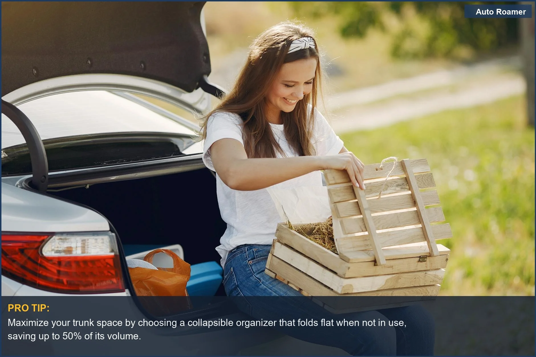 Woman happily unloading groceries from a car trunk, showcasing a collapsible trunk organizer in use.