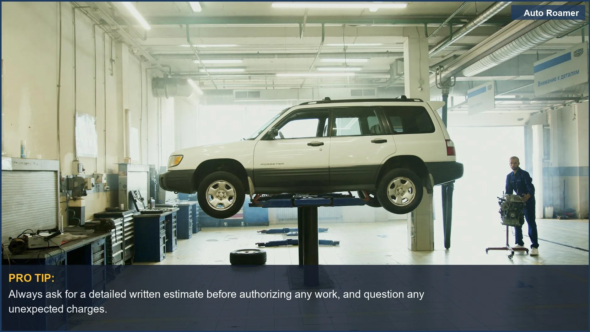 Mechanic inspecting a car on a lift, highlighting common auto repair scams like unnecessary part replacements.