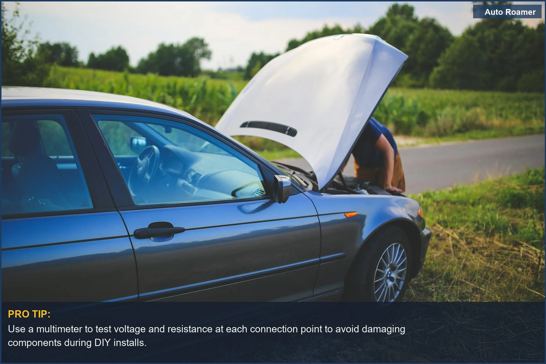 Man checking car engine with hood open on rural road, highlighting DIY electrical troubleshooting needs.