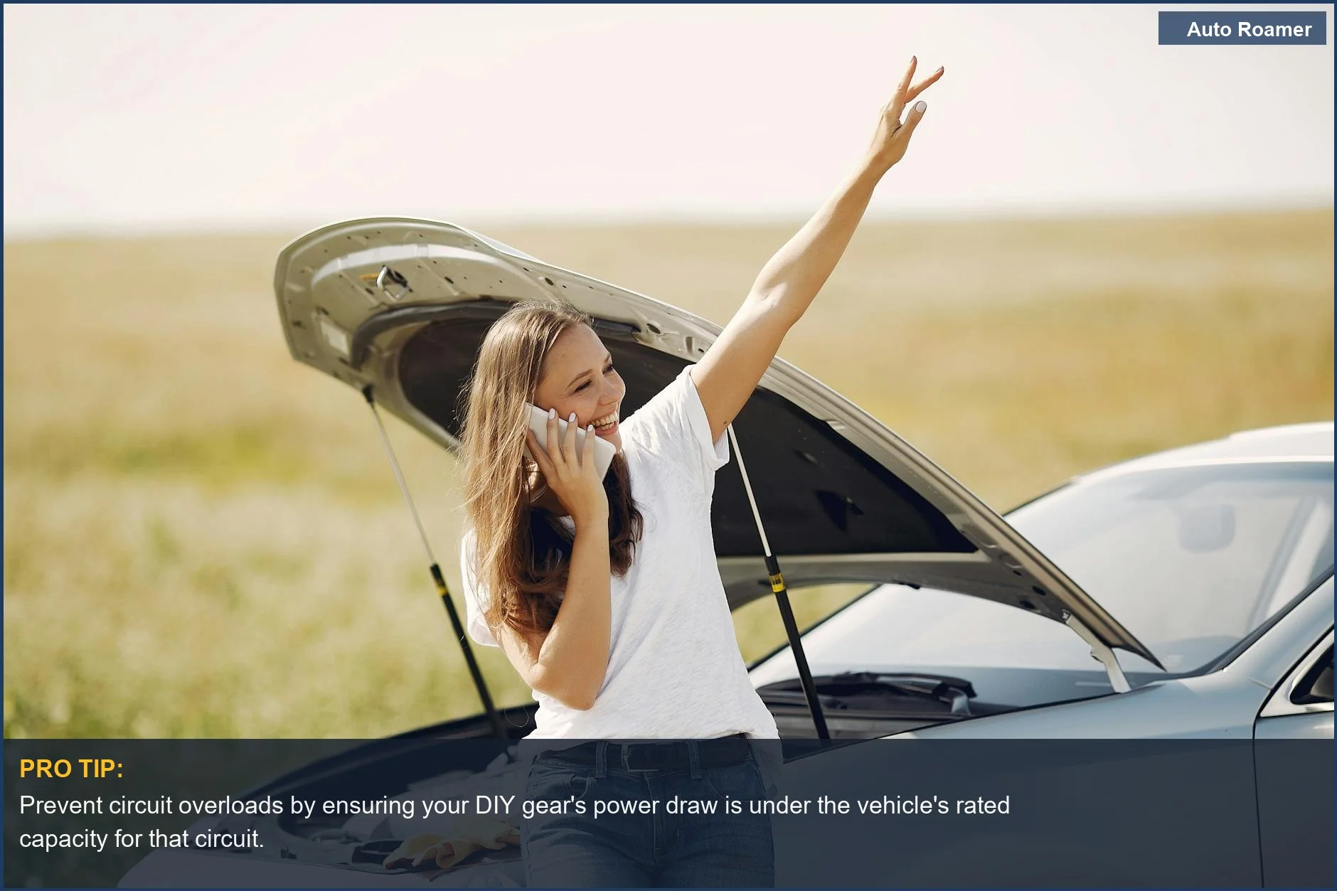 Woman smiling on phone near broken car with open hood, indicating common electrical failures from DIY installs.