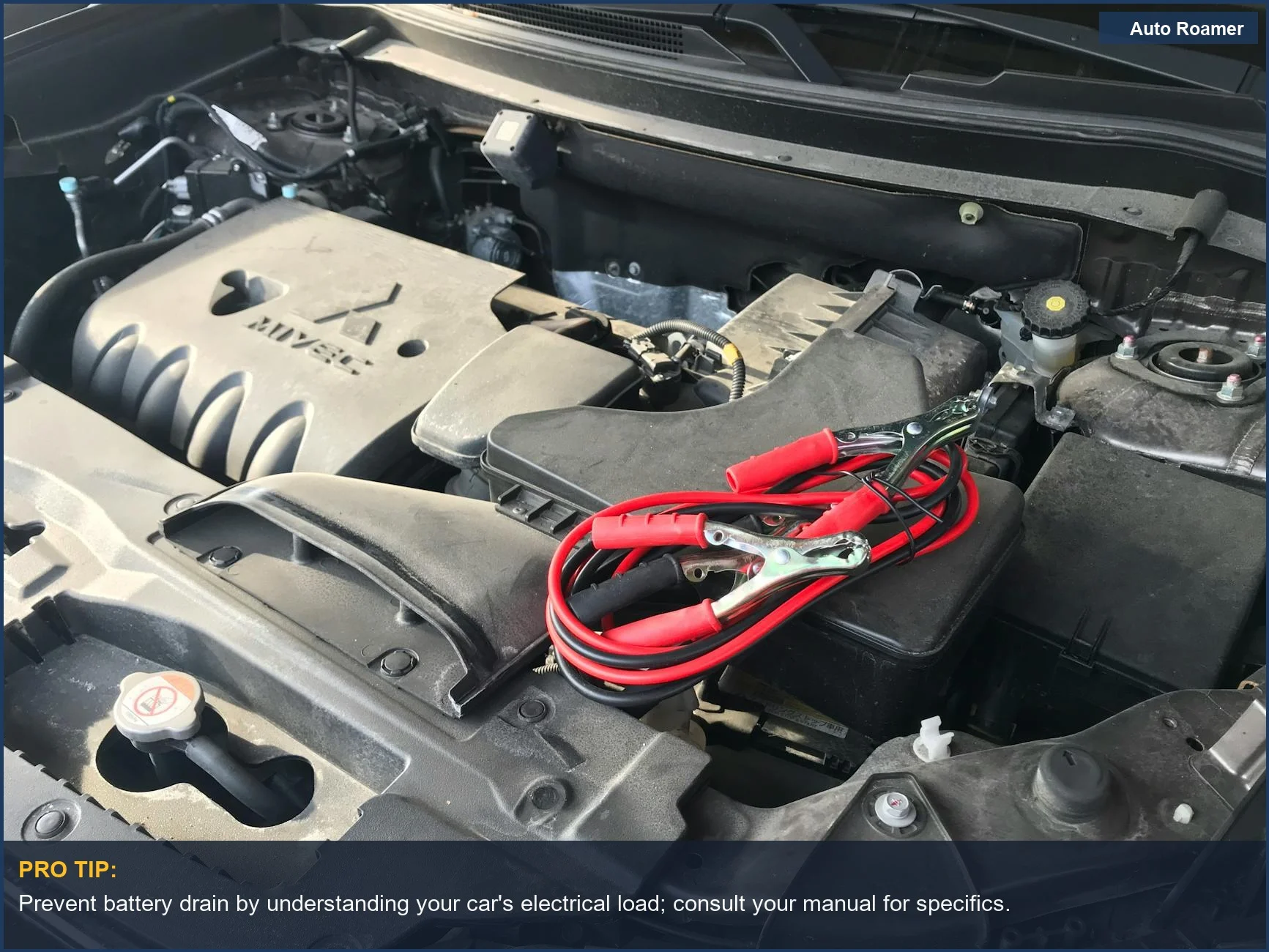 Compartimento del motor del coche con cables de arranque, ilustrando posibles problemas de consumo de batería del coche relacionados con la electrónica.