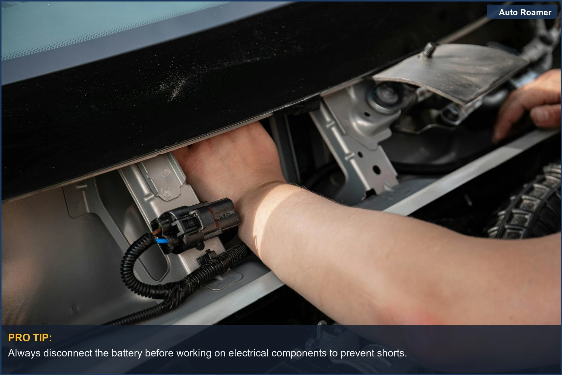 Skilled mechanic's hands carefully working on a car's electrical system, showing precision with fuse types.