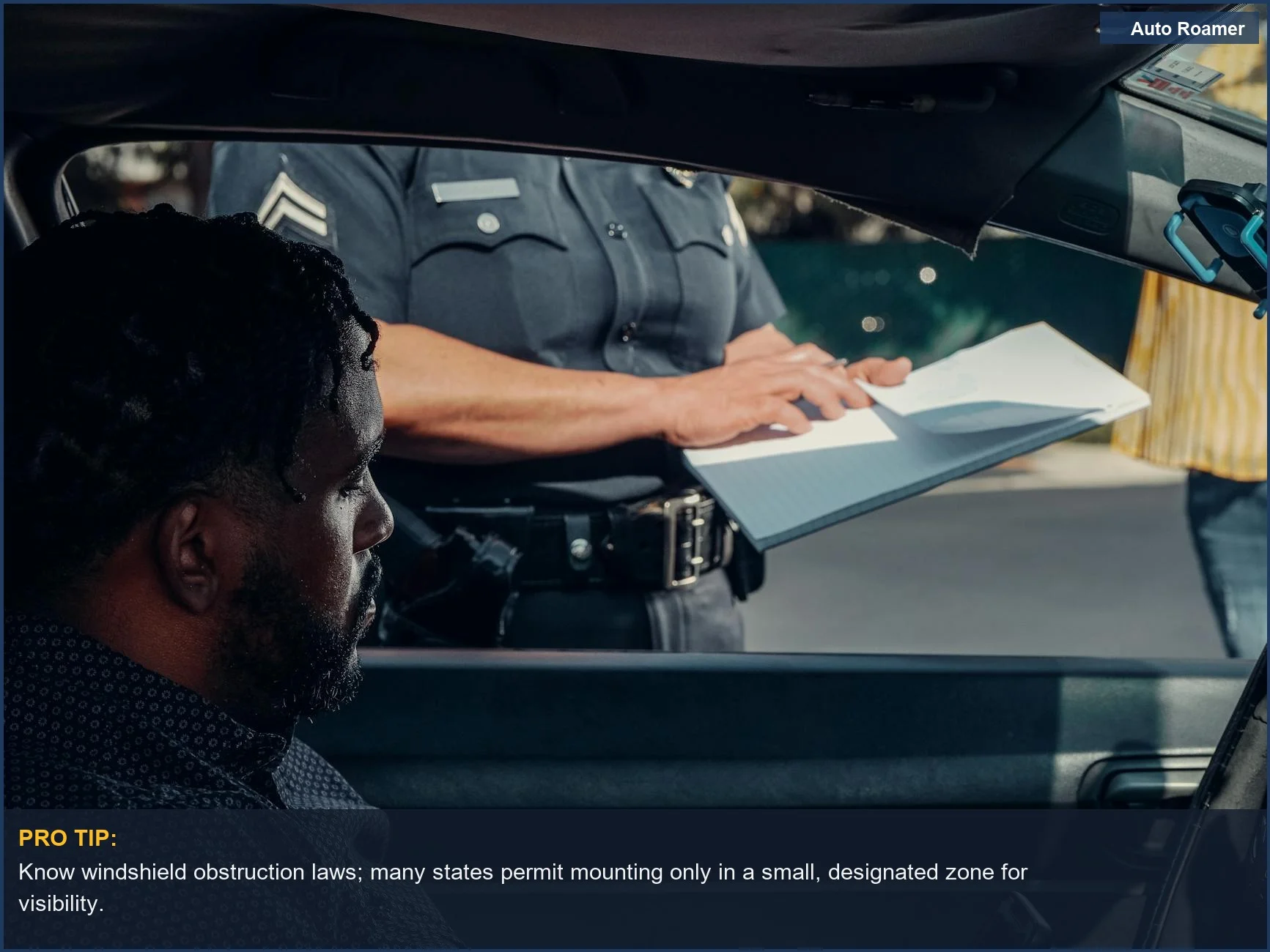 Close-up of a police officer issuing a traffic ticket through a car window, underscoring dash cam legal compliance.