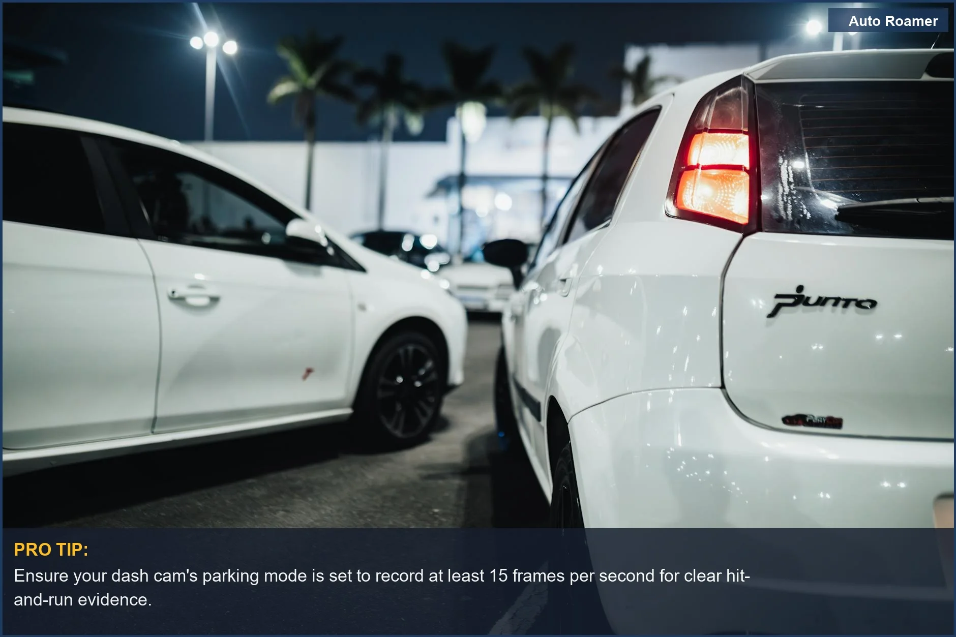 Nighttime urban street view of white cars parked under streetlights, showcasing dash cam parking mode.