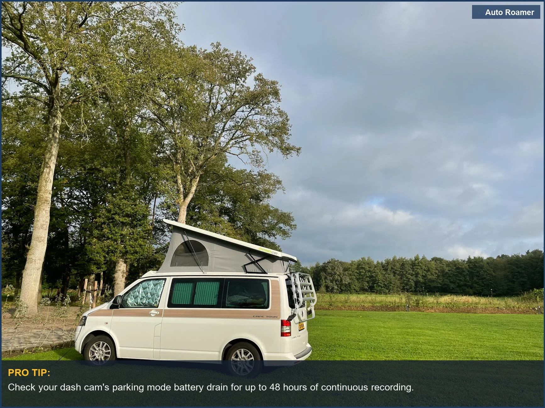Camper van in a green meadow, emphasizing its vulnerability to parking lot perils and the benefit of parking mode.