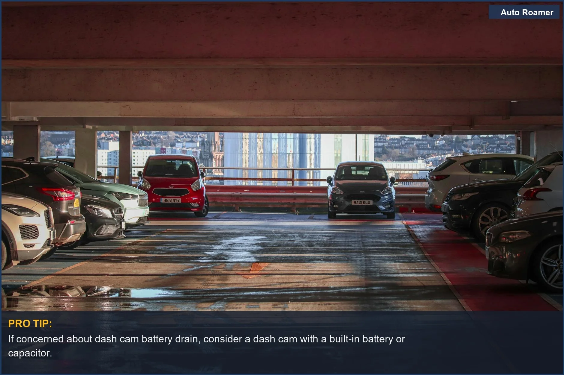 Parked cars in a multi-level garage overlooking a cityscape, ideal for dash cam battery drain discussions.