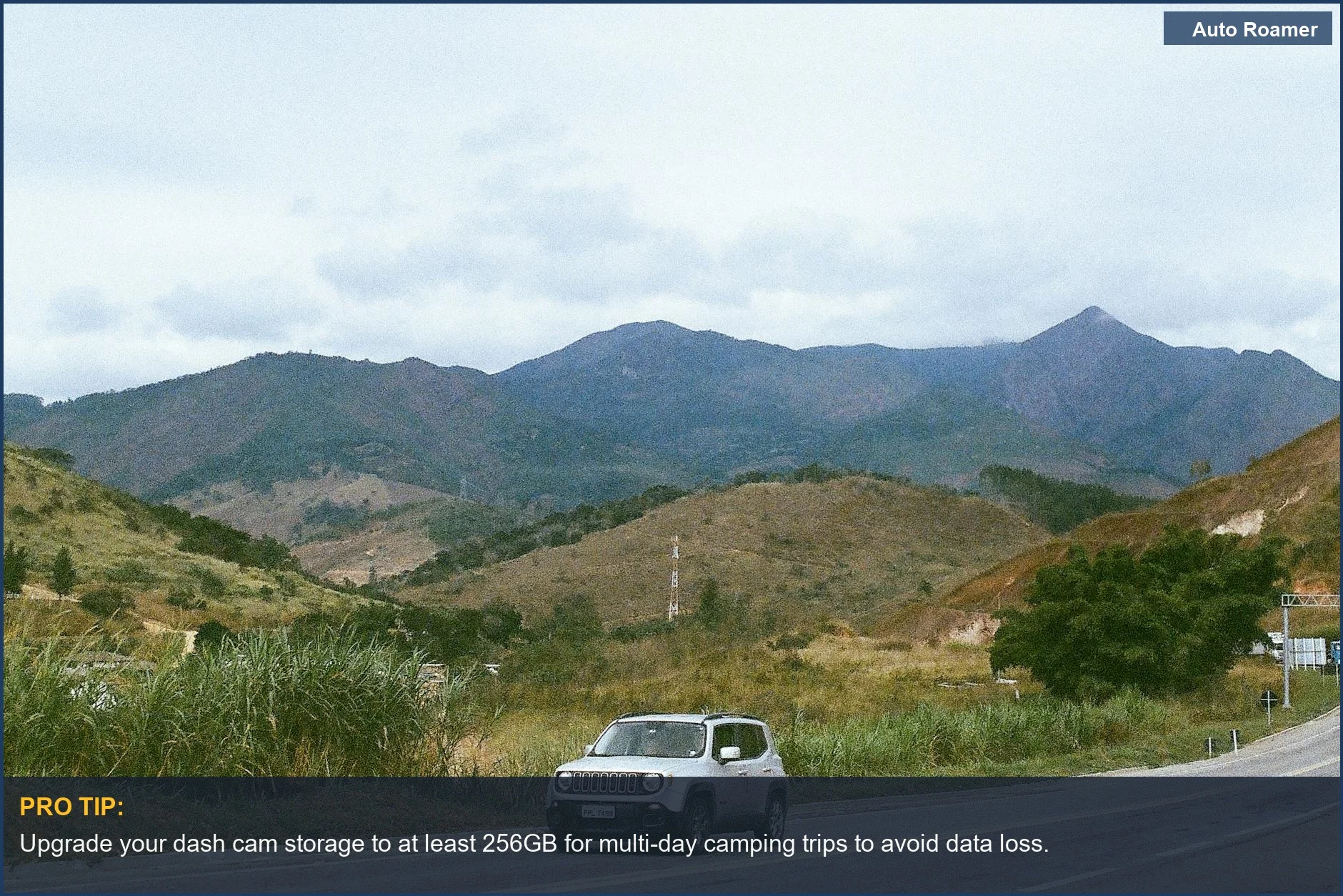 Kia Soul driving through majestic mountains, ideal for camping video storage needs.