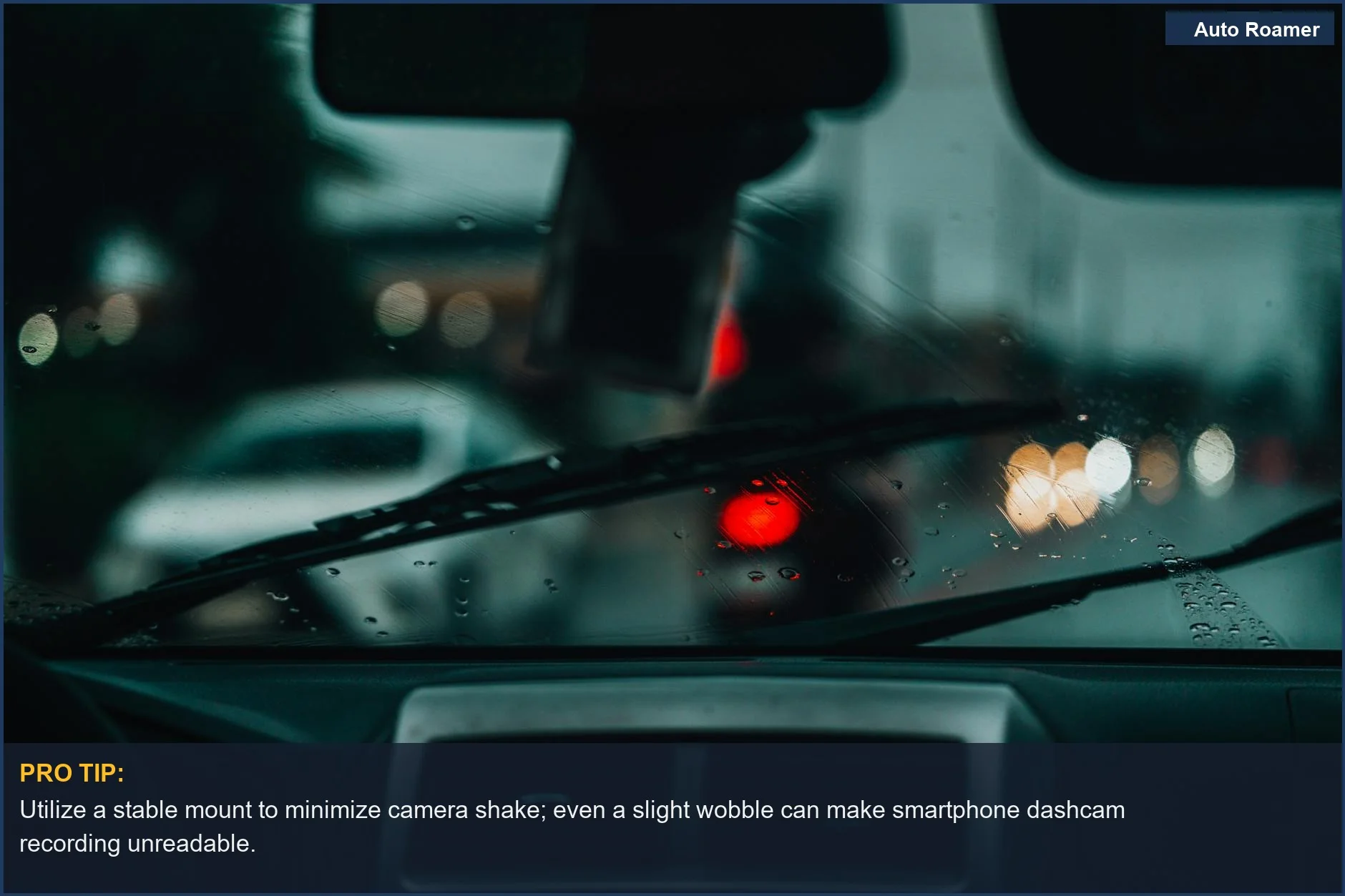 Raindrops on a windshield with blurred urban lights, showing the limitations of smartphone dashcam recording in adverse conditions.