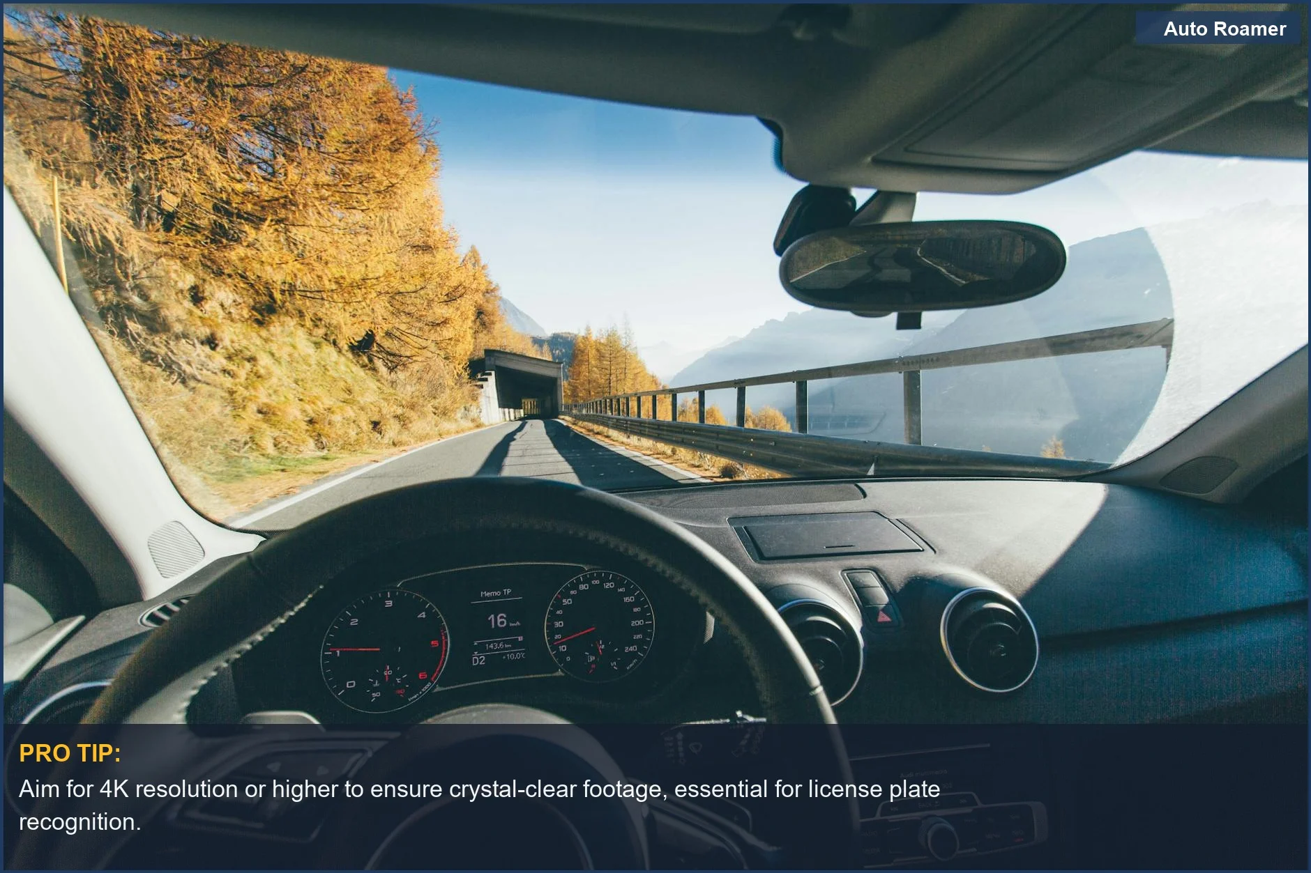 Scenic mountain road dashcam view capturing autumn foliage and clear skies for your dashcam buying guide.