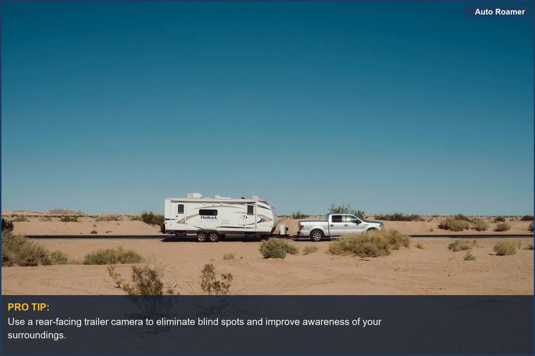 Camper trailer towed by a truck in a remote desert, emphasizing the benefits of a rear view dashcam for towing.