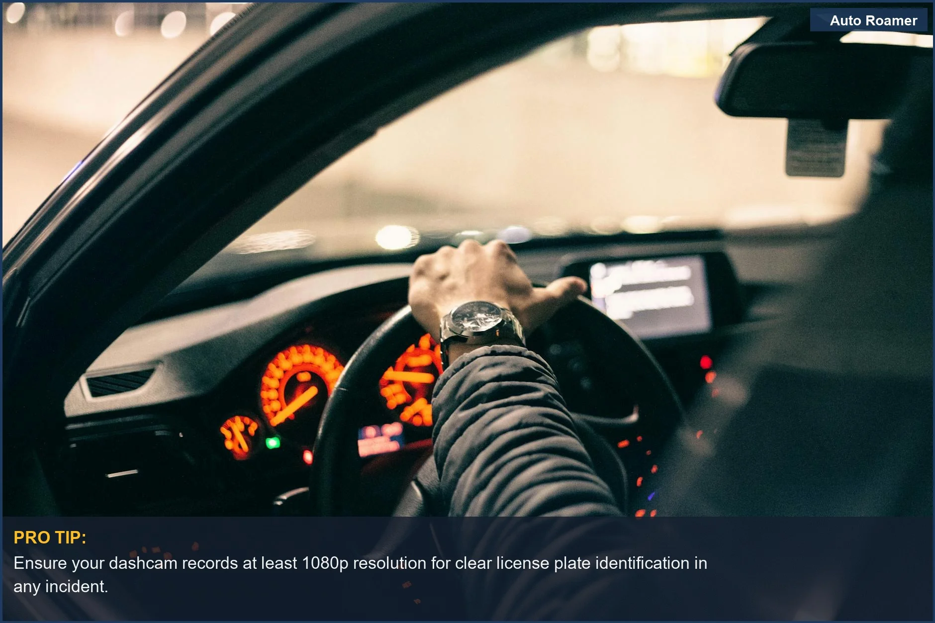 Driver's hands on steering wheel, dashboard illuminated, focusing on essential dashcam functions for a used car.