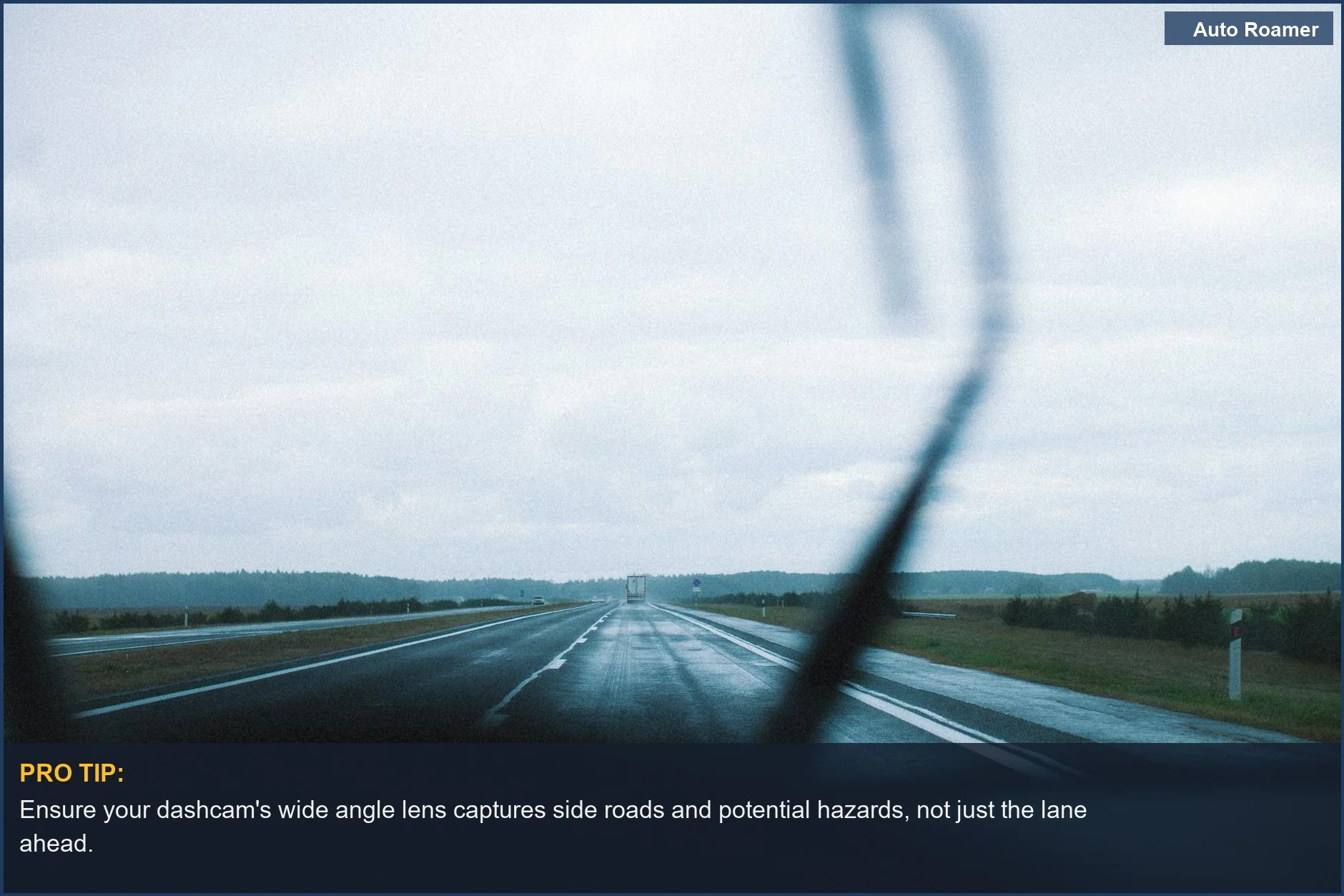 Rainy highway through windshield, emphasizing the need for wide angle dashcam for travel.