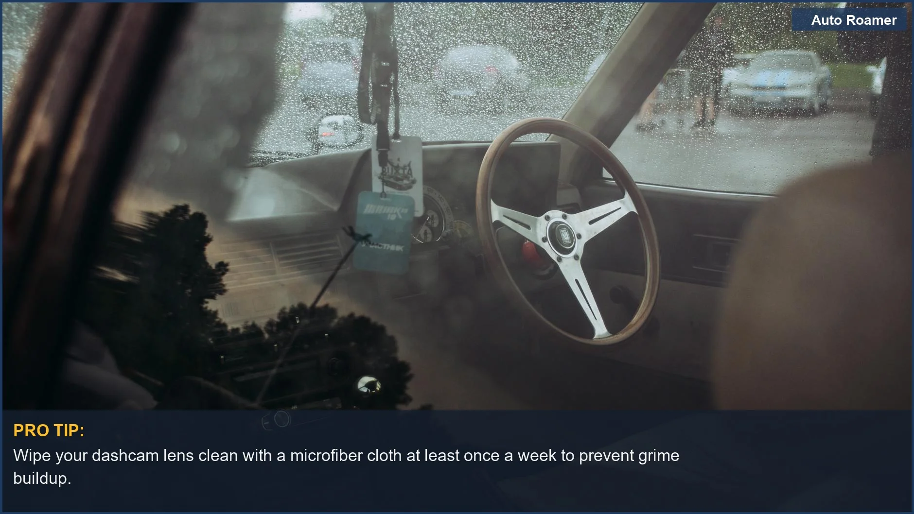 Rainy day car interior with blurry dashcam view of dashboard and steering wheel.