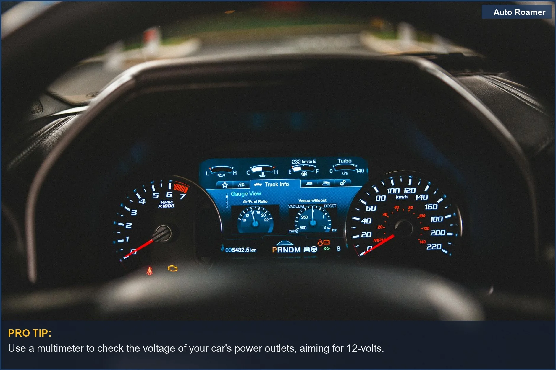 Modern car instrument panel seen through steering wheel, relevant for dashcam power in older vehicles.