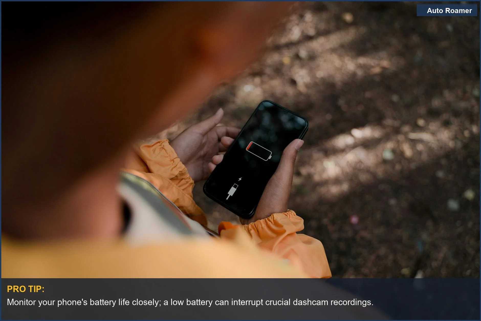 Teenager holding a smartphone with a low battery, illustrating potential issues with using a phone as a dashcam.