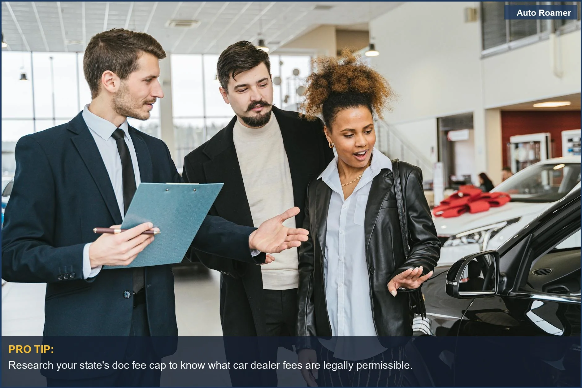 Diverse adults discuss vehicles at a dealership, emphasizing what car dealer fees you should pay.