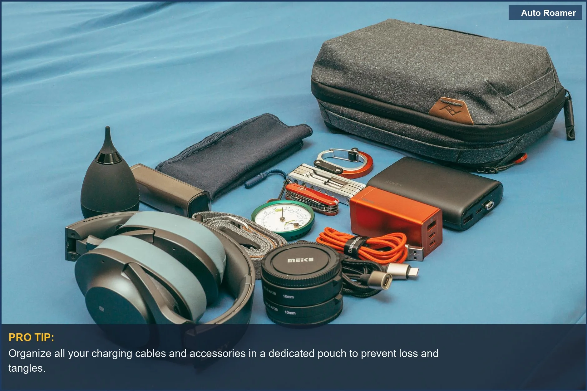 Flat lay of travel gear, including headphones and a power bank, essential for road trip electronics.