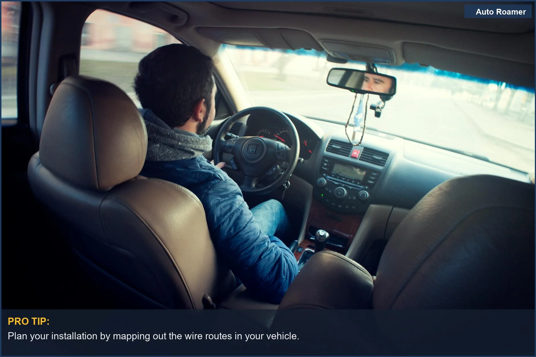 Man driving a car, focusing on the dashboard and steering wheel.