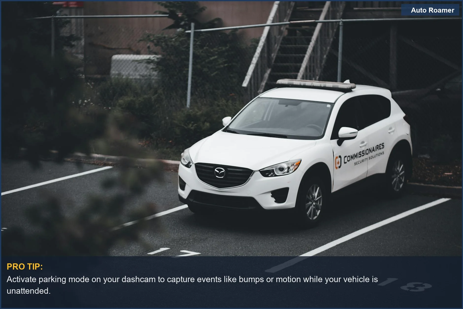 White SUV with security branding in an outdoor numbered spot, illustrating vehicles that can benefit from dashcams recording when the car is off.
