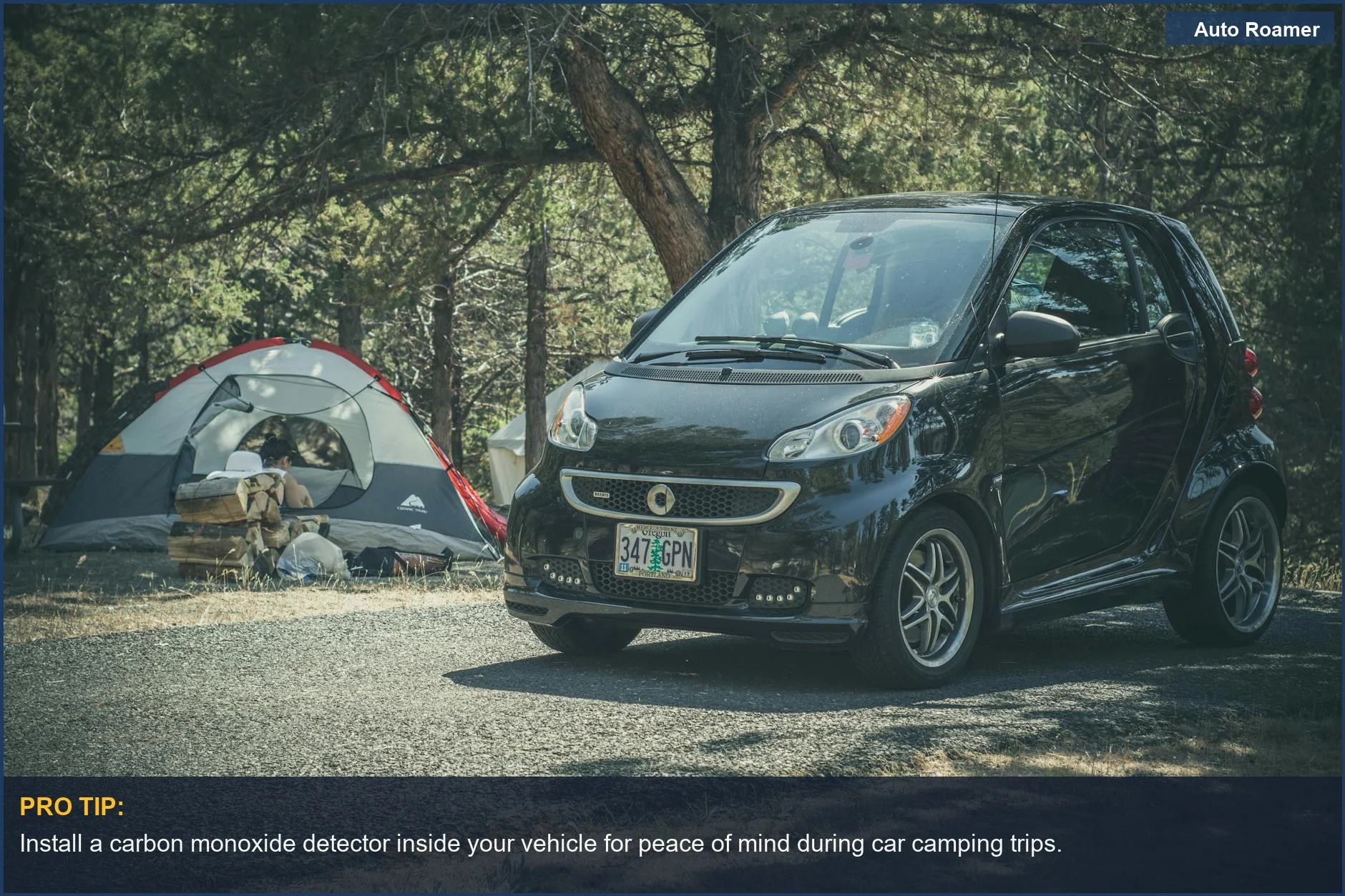 Smart car parked beside a tent, showing the importance of a carbon monoxide detector for camping safety.