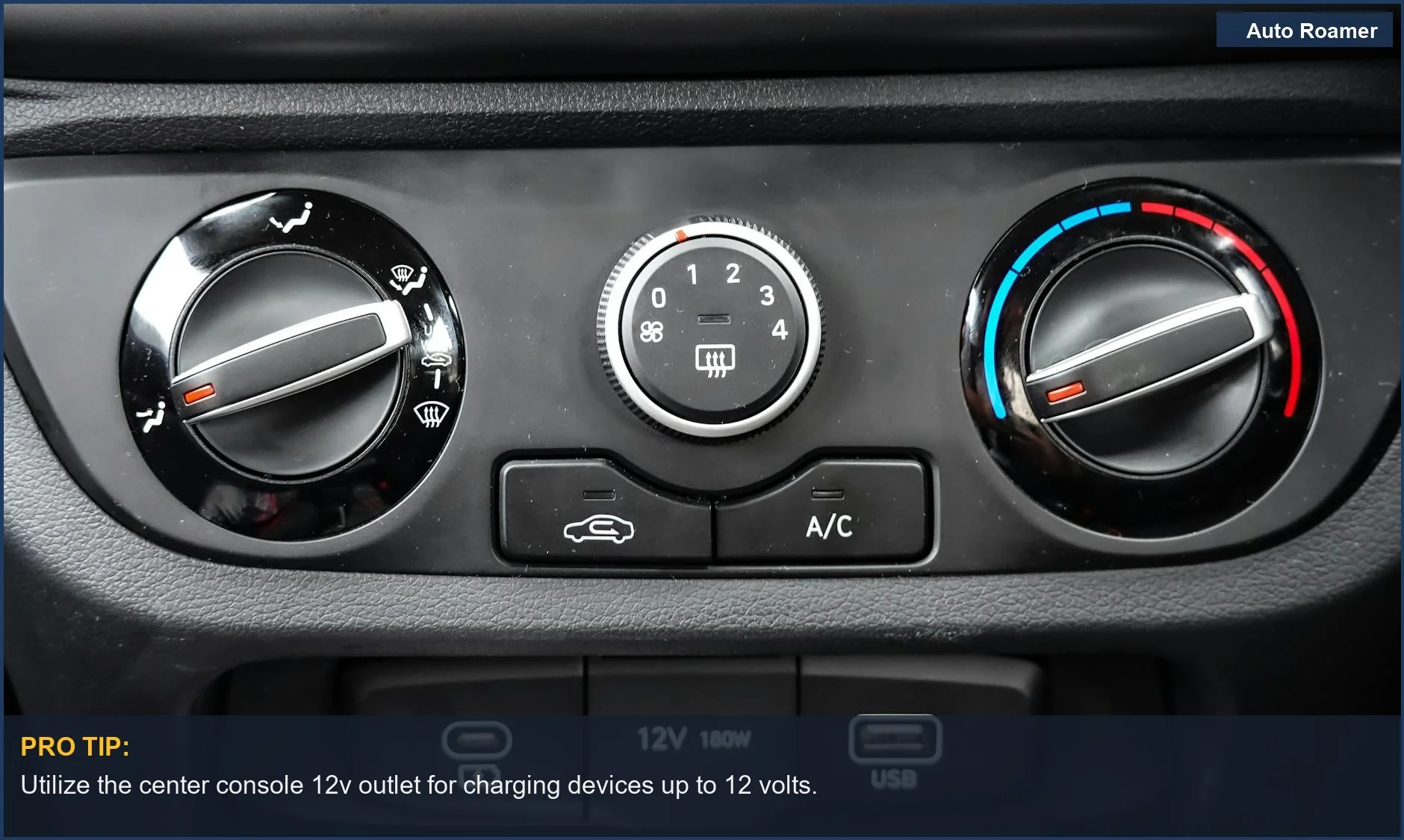 Close-up of Tesla Model Y center console climate controls and connectivity ports for 12v power.