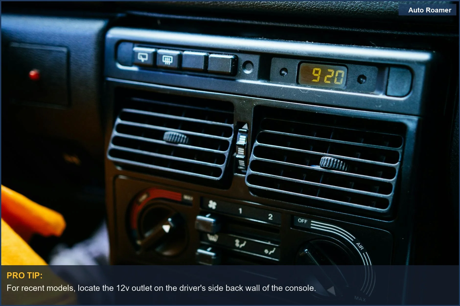 Tesla Model Y dashboard with control knobs and digital clock, confirming 12v outlet placement.