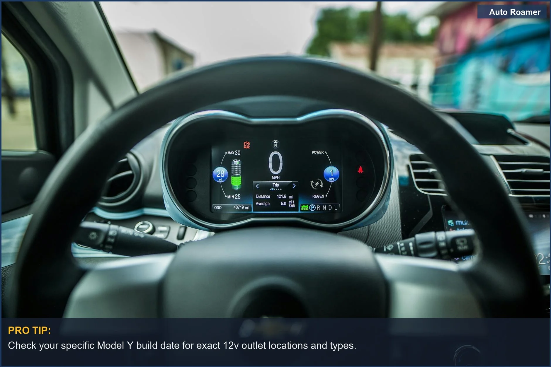Tesla Model Y dashboard interior with digital display and steering wheel, showing 12v outlet availability.