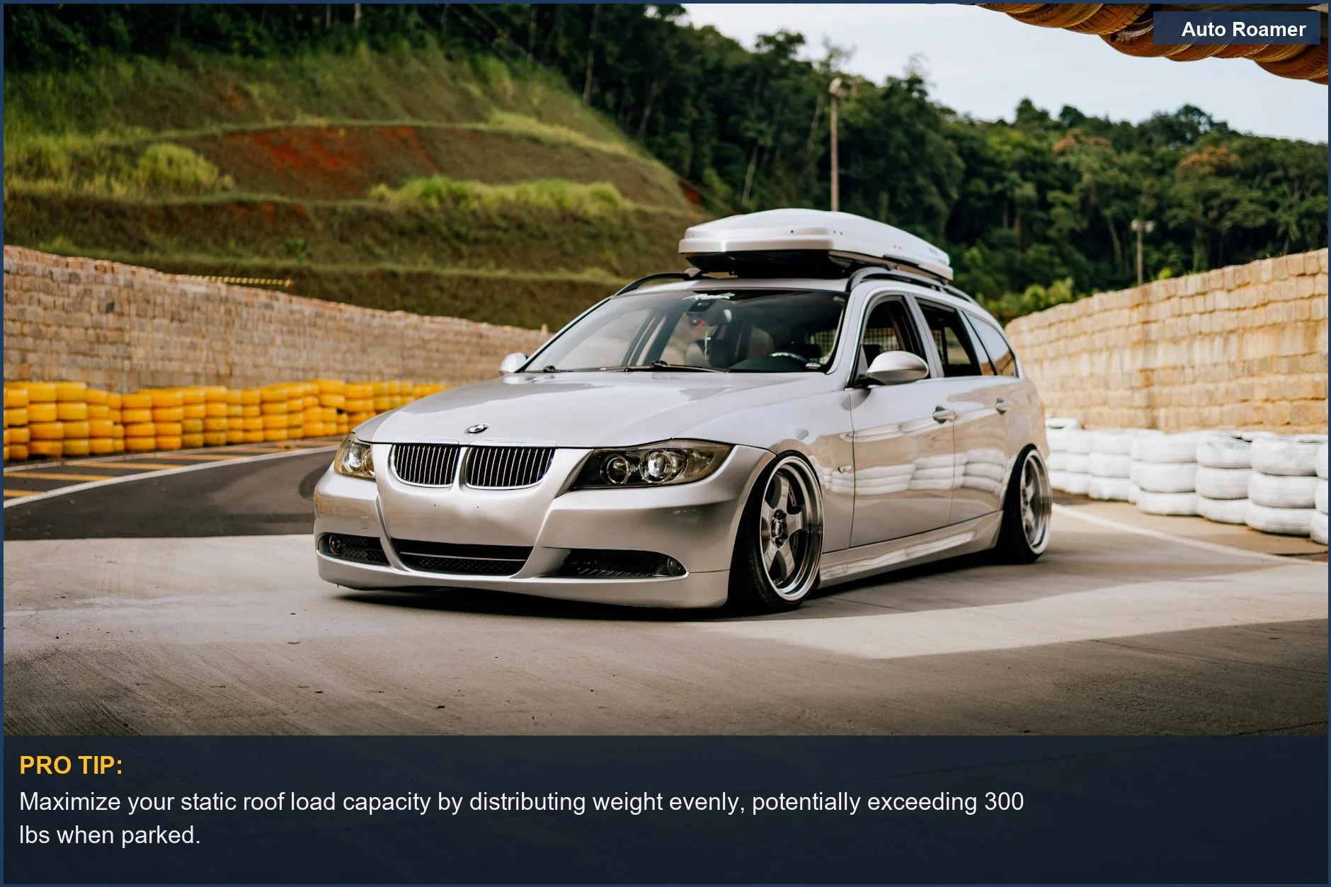 Silver BMW station wagon with roof box at a car meet, highlighting static roof load capacity for Santa Fe adventures.
