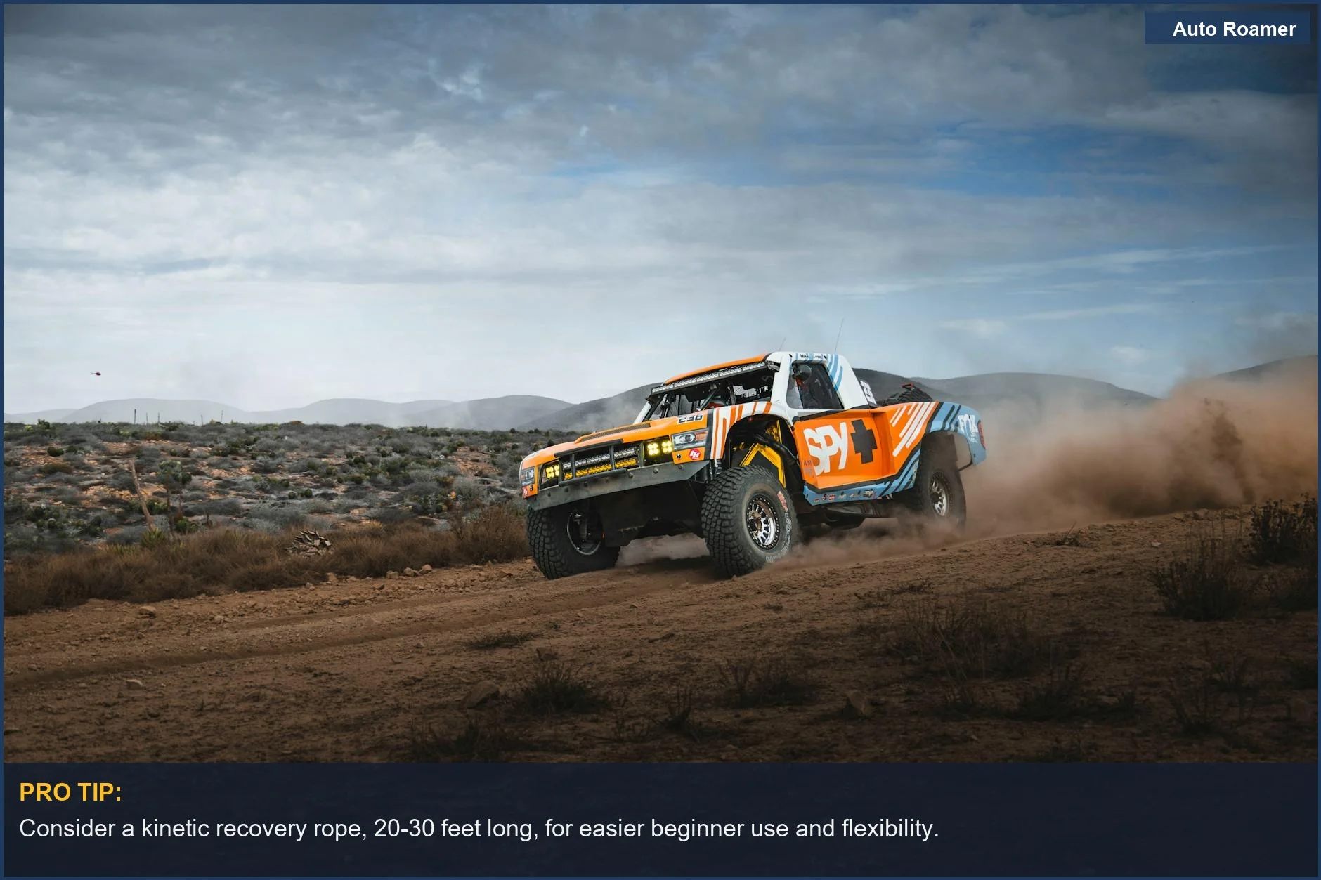 High-speed off-road rally truck dust in Baja desert, vital overlanding tools for self-rescue.