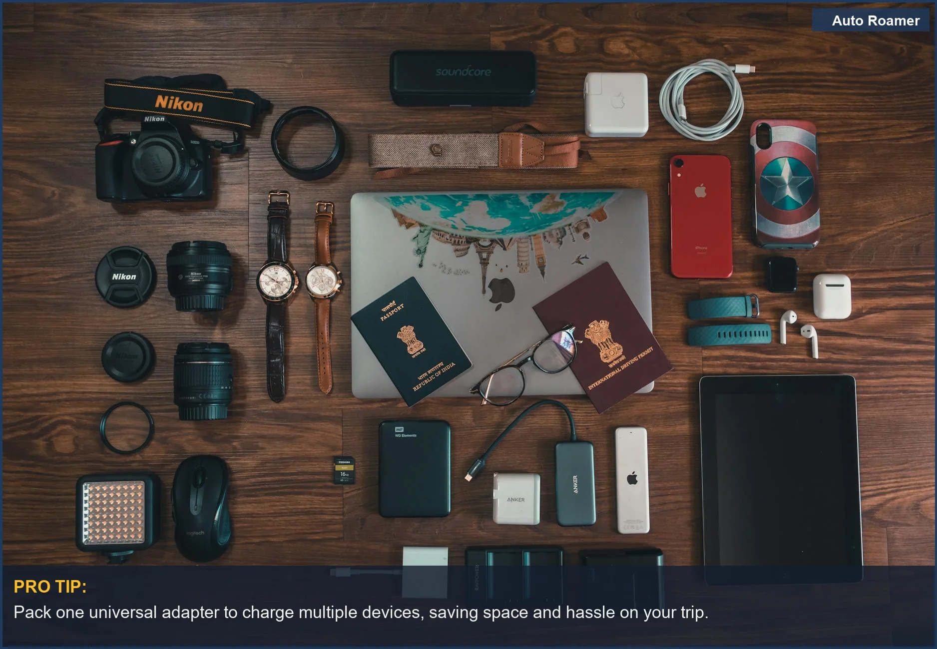 Flat lay of travel essentials including gadgets, passports, and camera, highlighting organized road trip electronics.