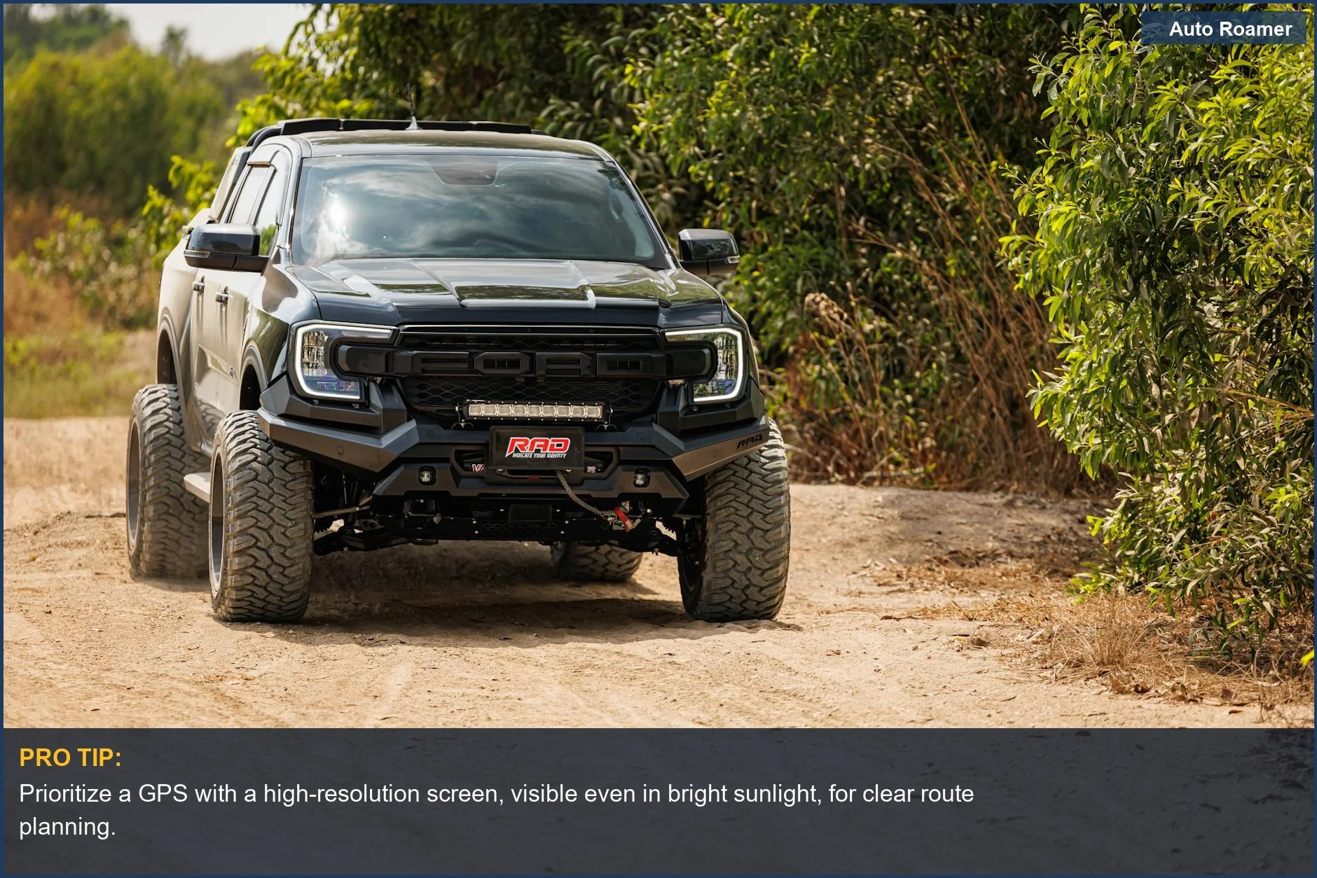 Black pickup truck navigating a rugged off-road trail, demonstrating GPS navigation system requirements for challenging routes.