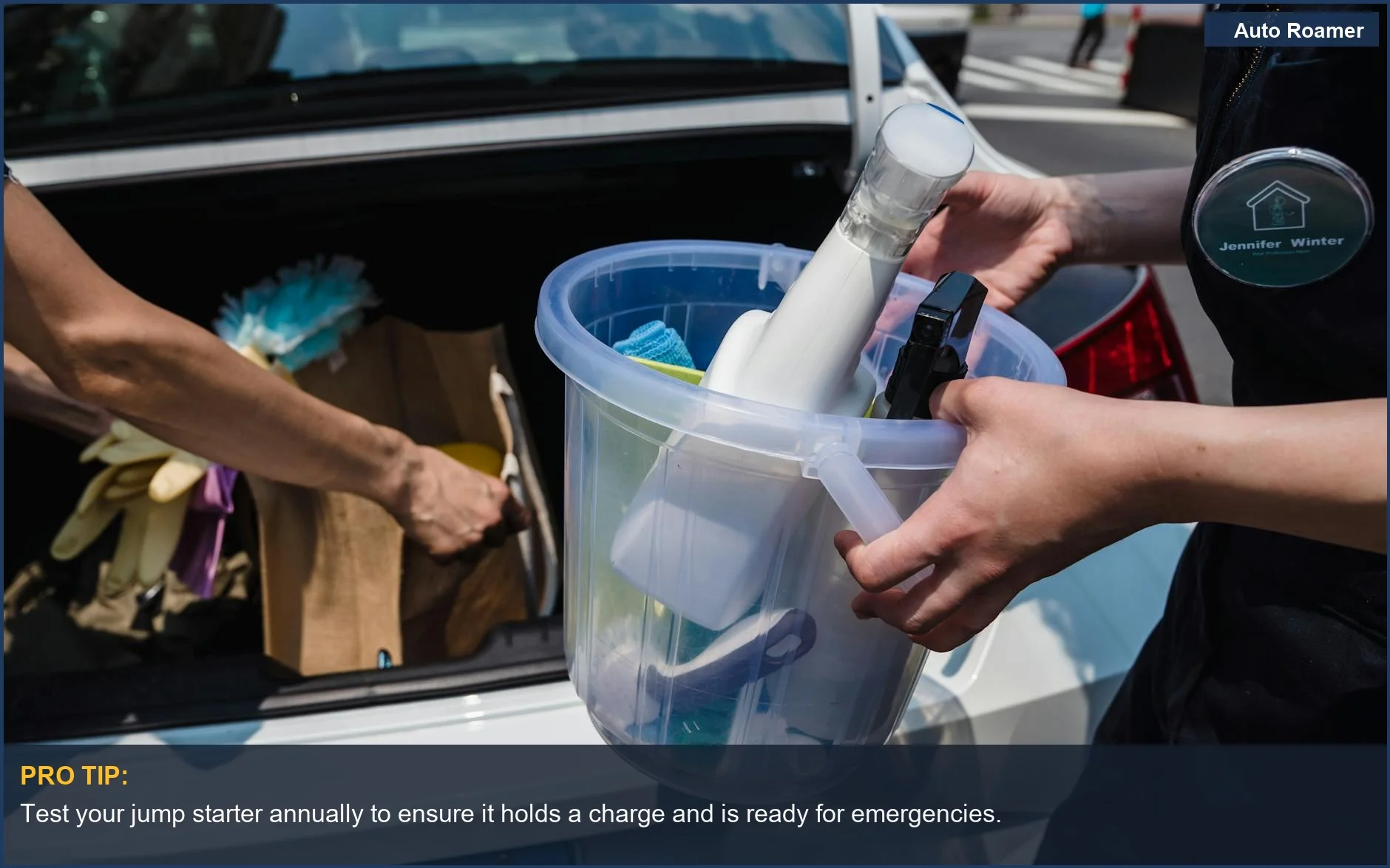 Close-up of jumper cables and cleaning supplies for car kit preparedness.