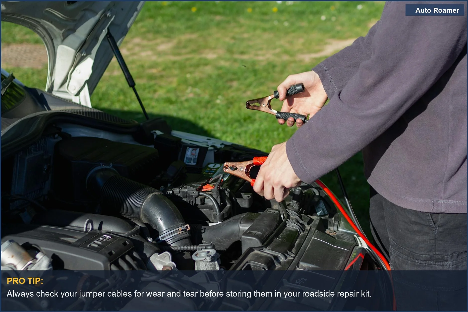 Close-up of jumper cables connecting to a car battery for a roadside jump-start.