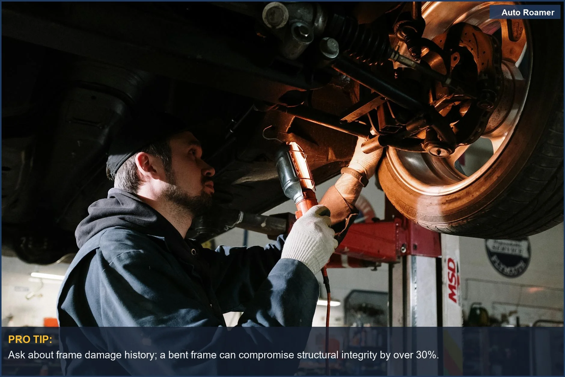 Mechanic examining car's undercarriage, essential for evaluating used family vehicles for hidden safety issues.