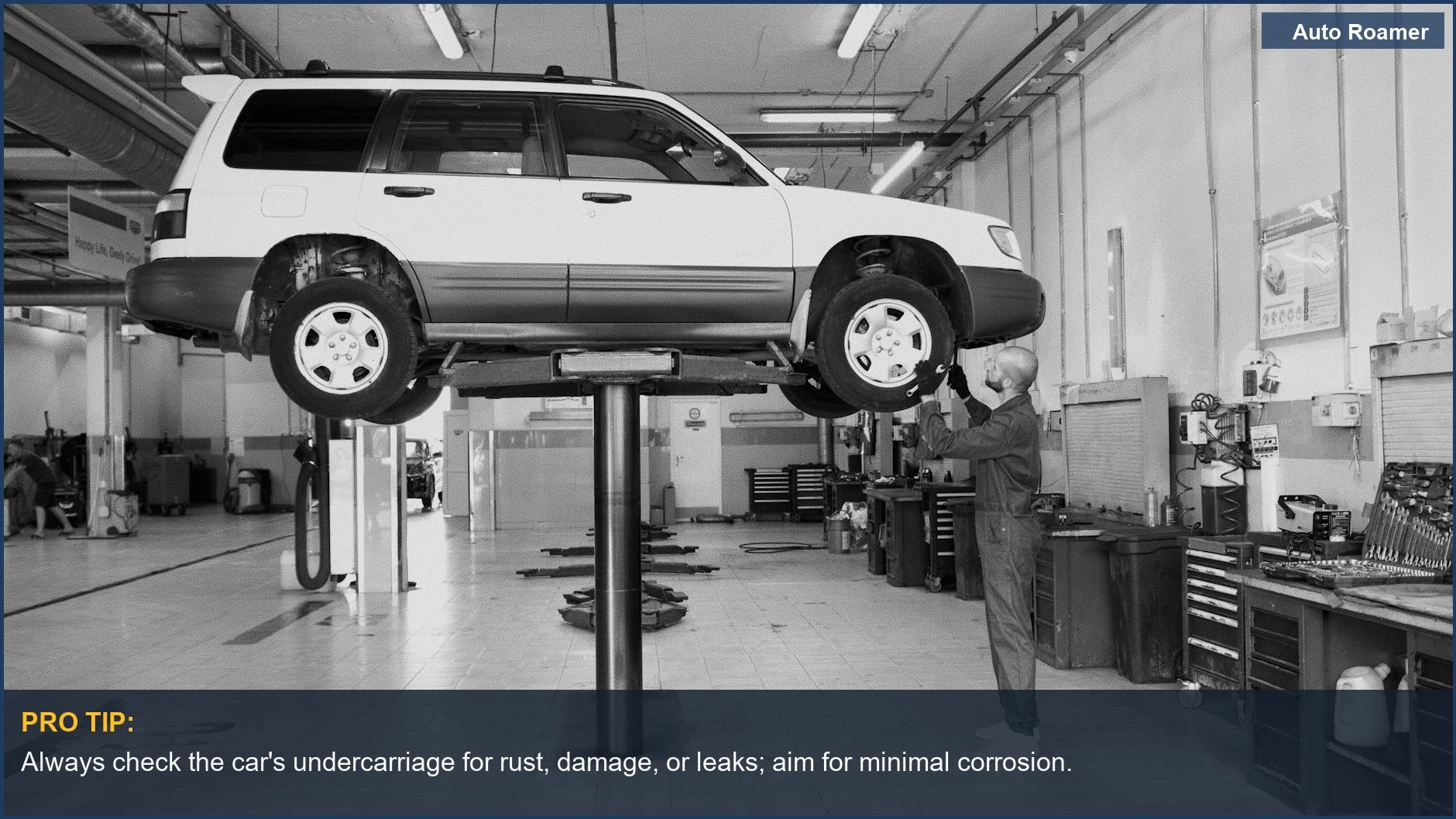 Mechanic examining an elevated car, a vital step in assessing used family vehicles for safety concerns.