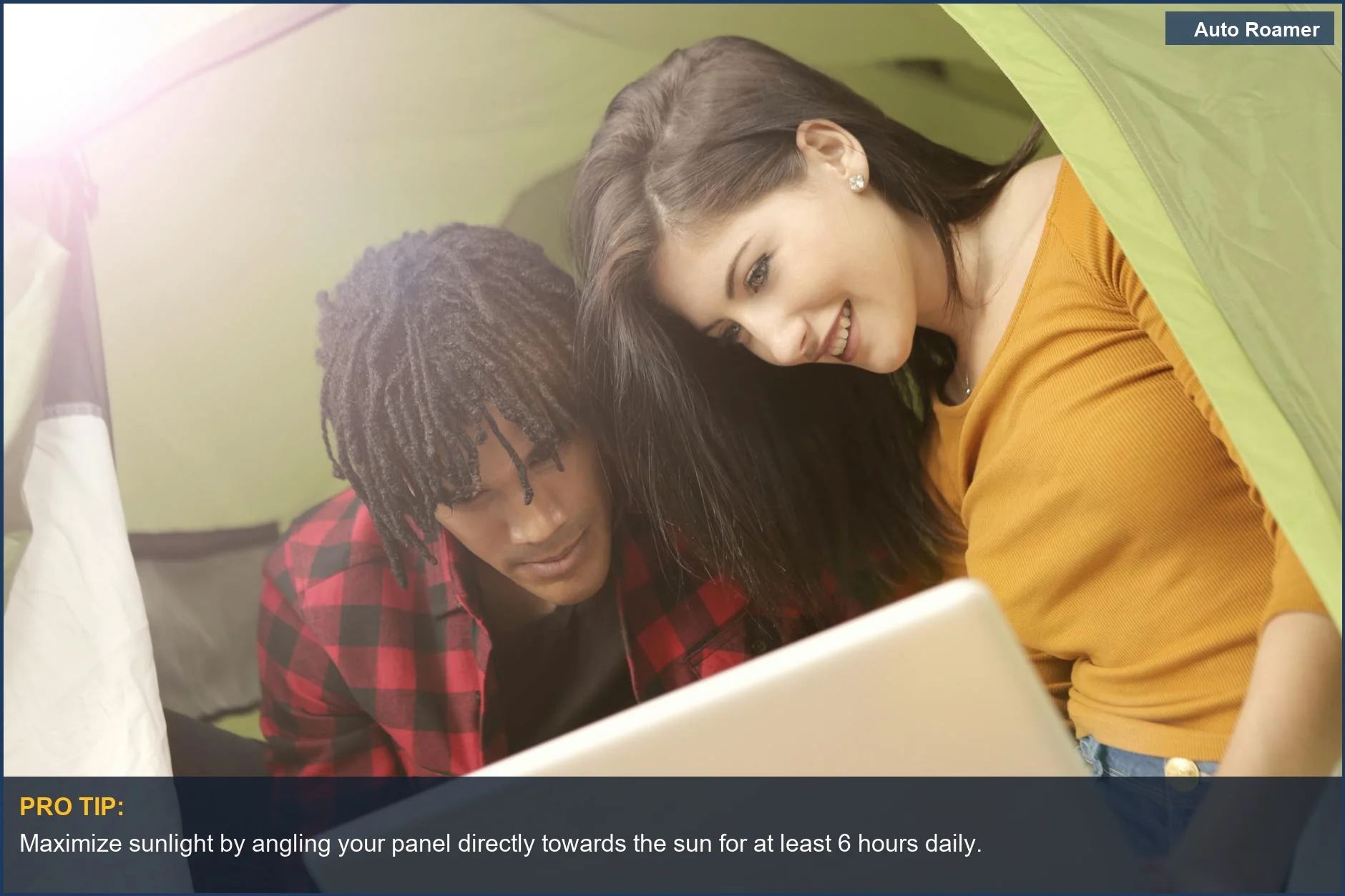 Couple using laptop in sunny camping tent highlights the importance of direct sunlight for camping solar power.