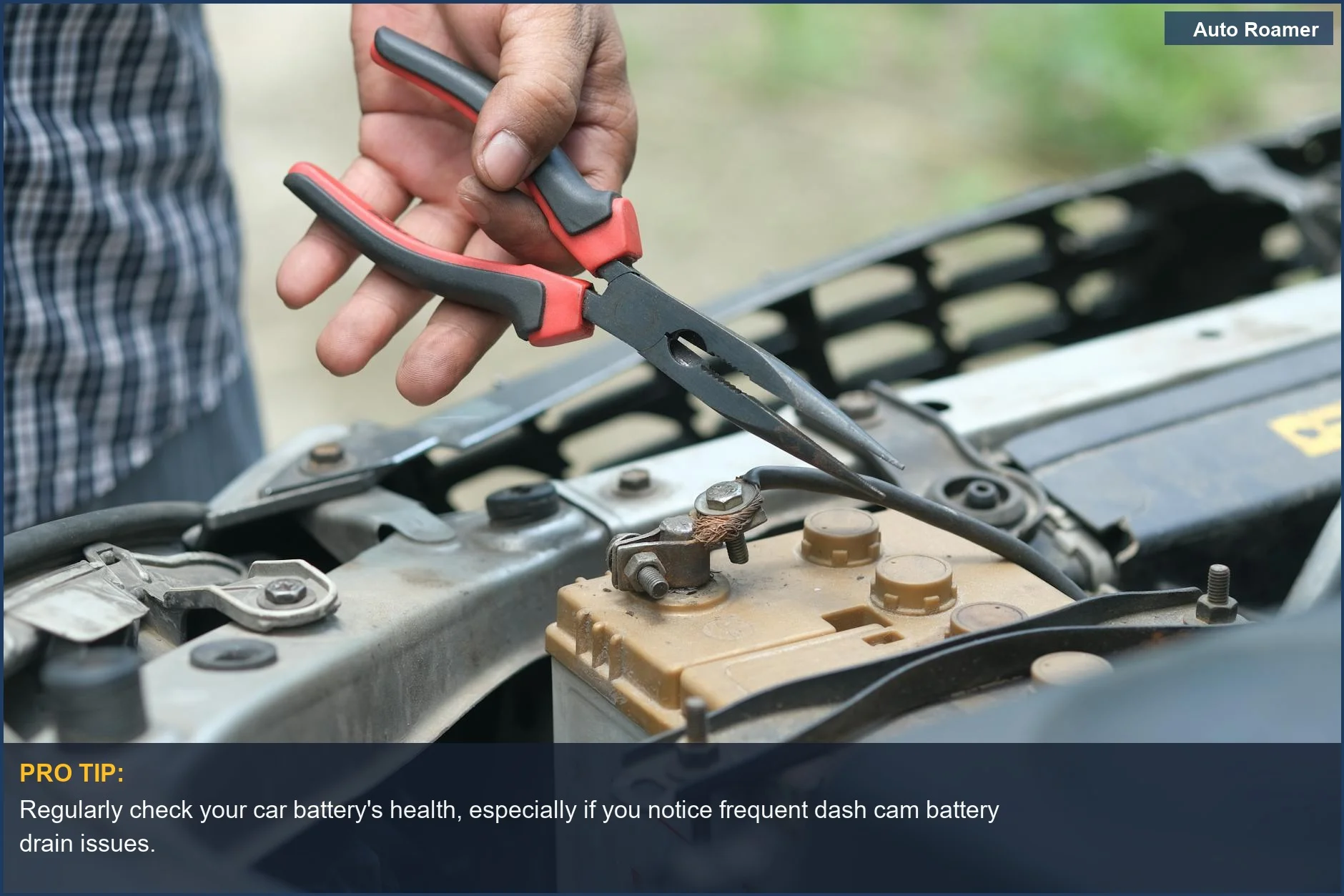 Person inspecting car battery with pliers, emphasizing the impact of dash cam battery drain on vehicle operation.