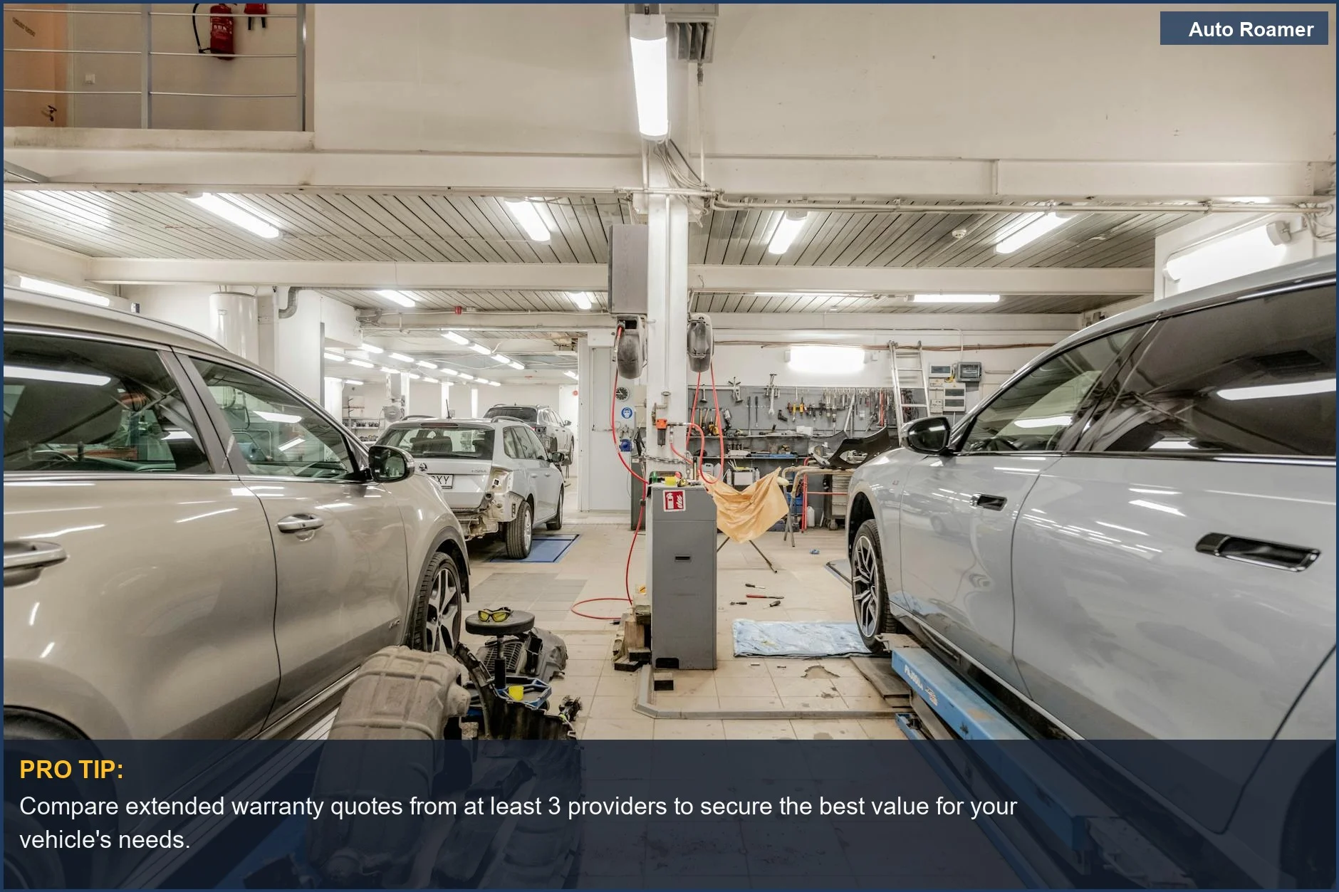 Automotive repair shop interior with cars undergoing maintenance, symbolizing the benefits of an extended car warranty.