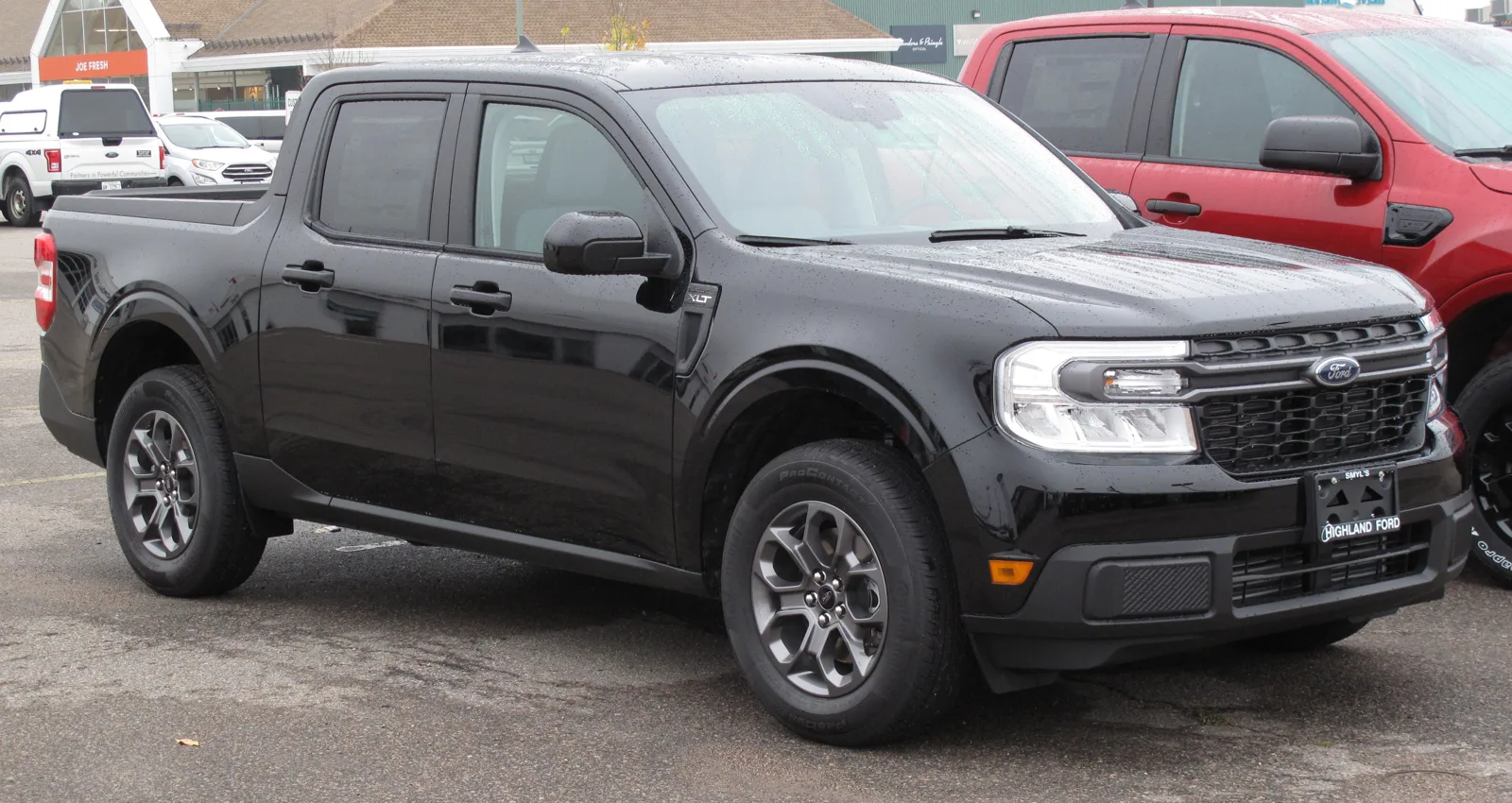 A black Ford Maverick compact pickup, the small truck whose bed dimensions for camping this guide measures