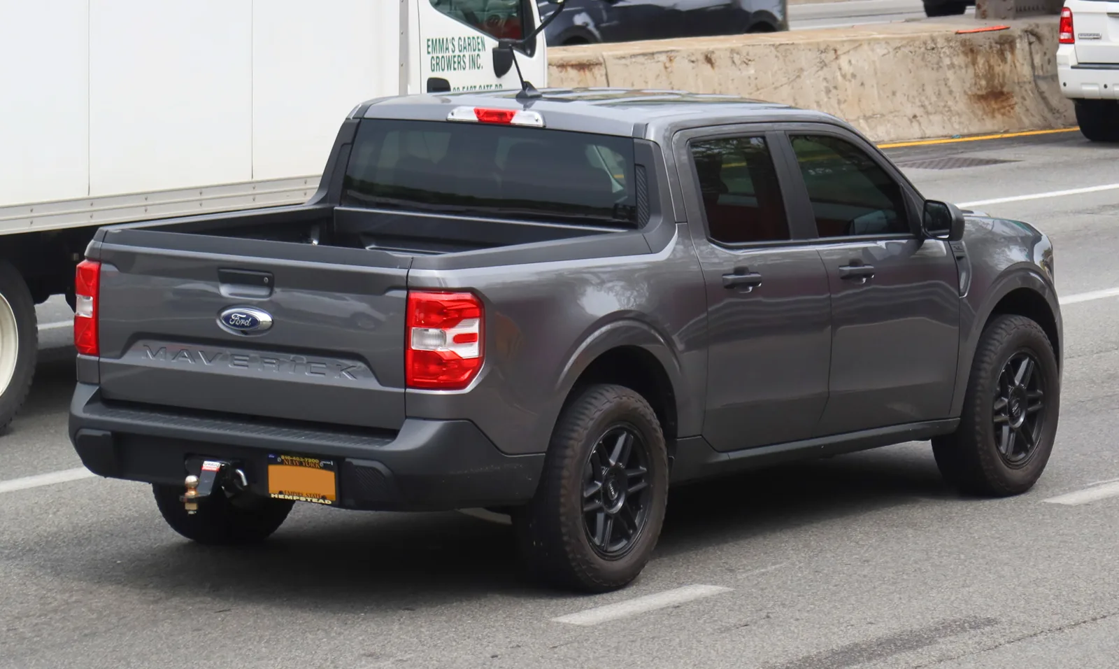 A gray Ford Maverick seen from the rear showing its short truck bed and tailgate, the camping bed this guide sizes up