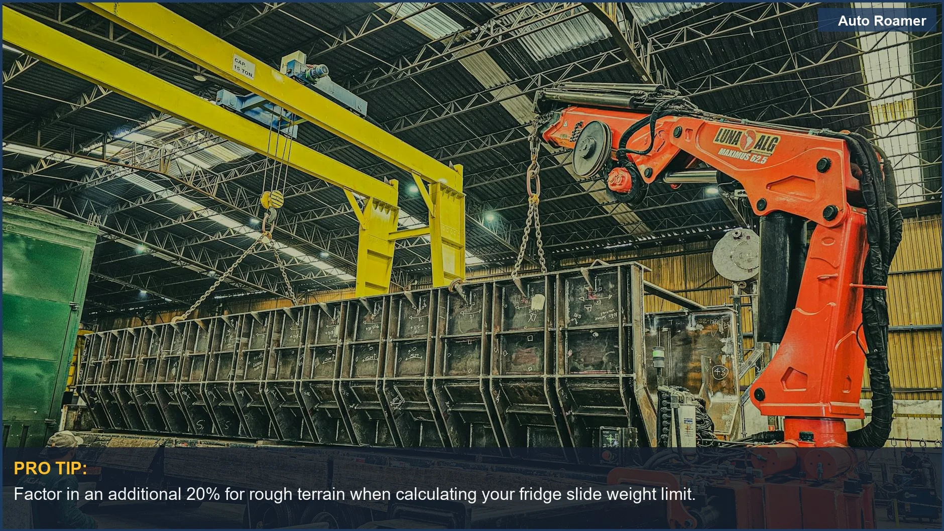 Large crane lifts a container onto a truck in a warehouse, highlighting the importance of exceeding fridge slide weight limits.
