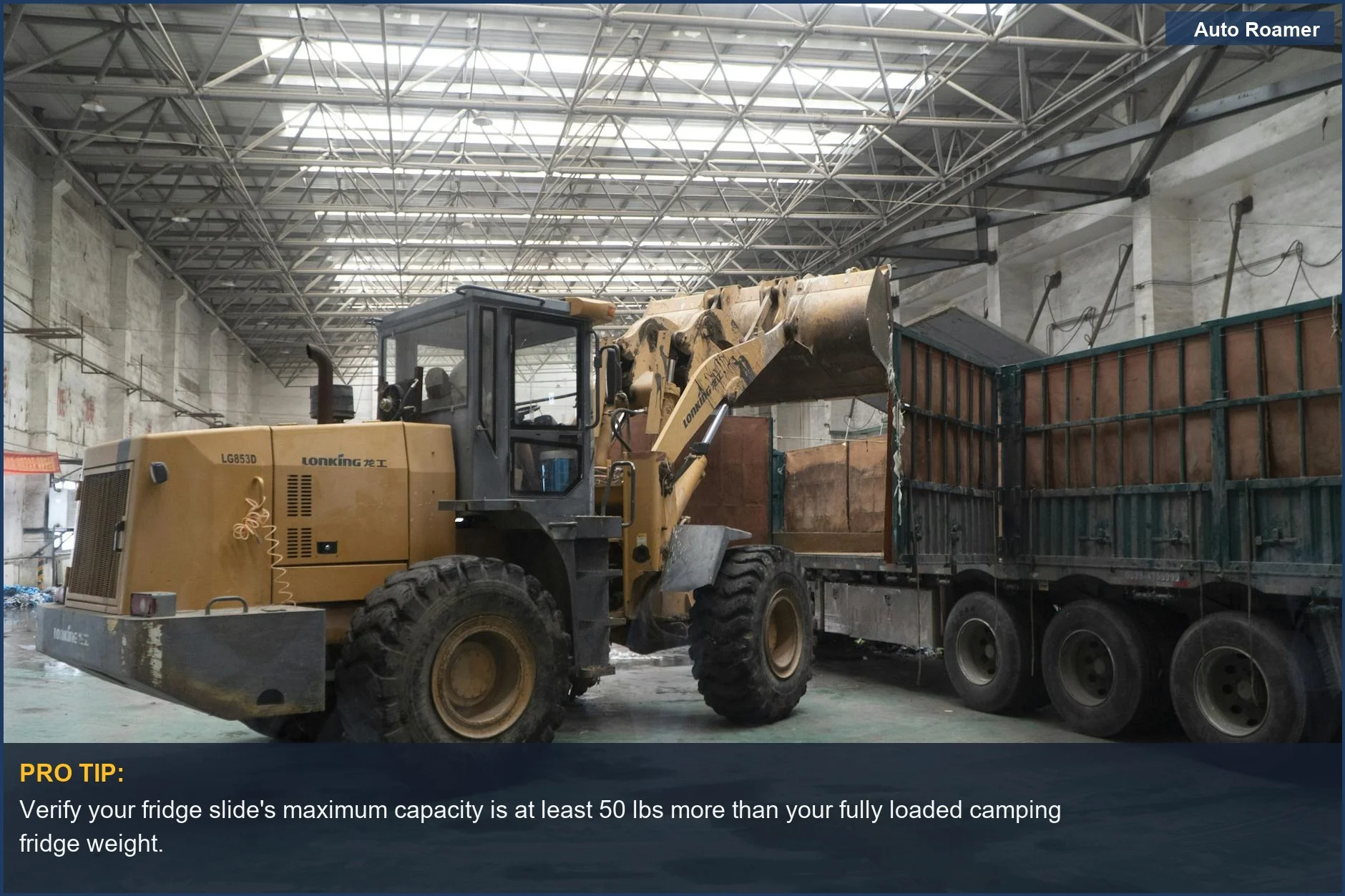 Heavy-duty loader transfers materials onto a truck inside a warehouse, emphasizing the need for strong fridge slide weight limit.