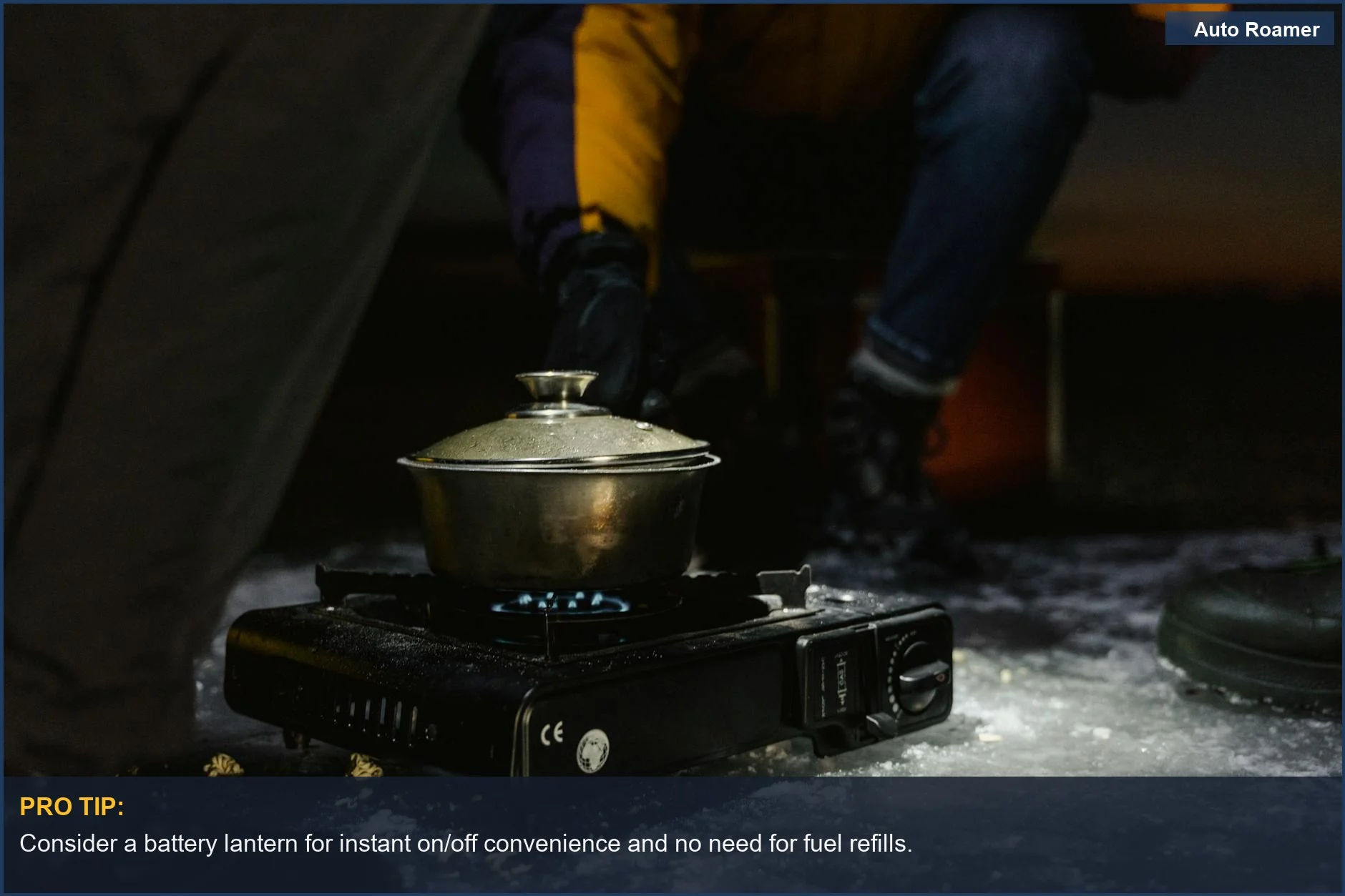 Portable stove with food on snowy ground for winter camping, highlighting battery lantern alternatives.