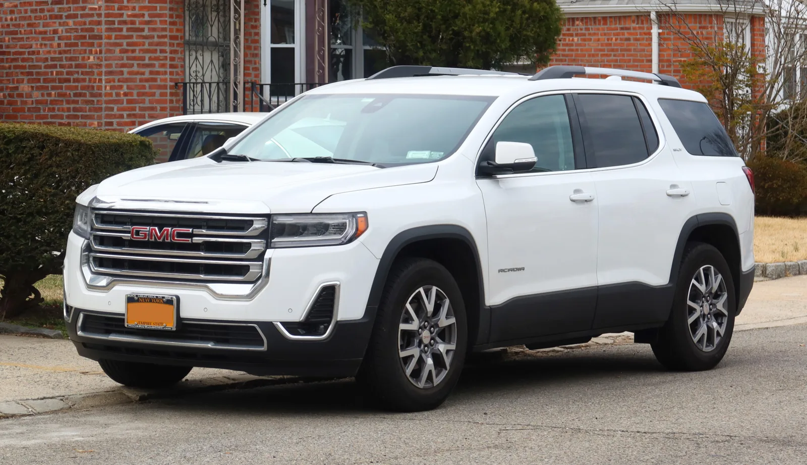 A white GMC Acadia SUV, the crossover whose cargo dimensions for sleeping this guide translates into a bed