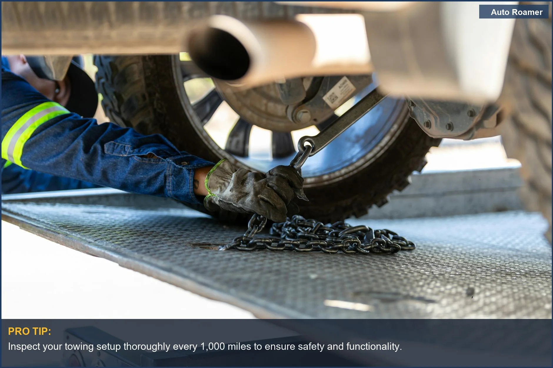 Mechanic securing a vehicle on a platform for safe towing maintenance.