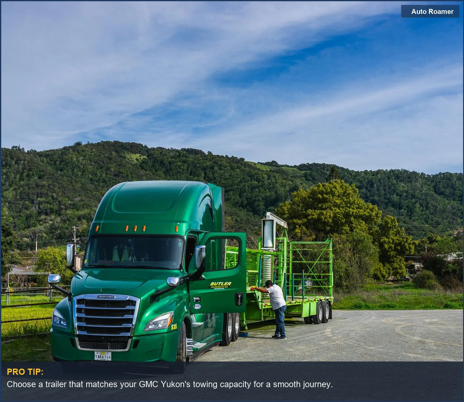 Vivid green GMC Yukon with trailer in a picturesque landscape, ideal for towing adventures.
