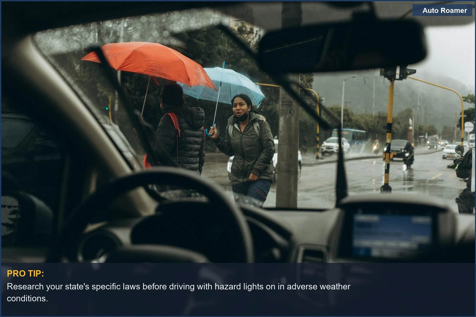 View through car windshield of people with umbrellas on a wet street, showing varying weather conditions.
