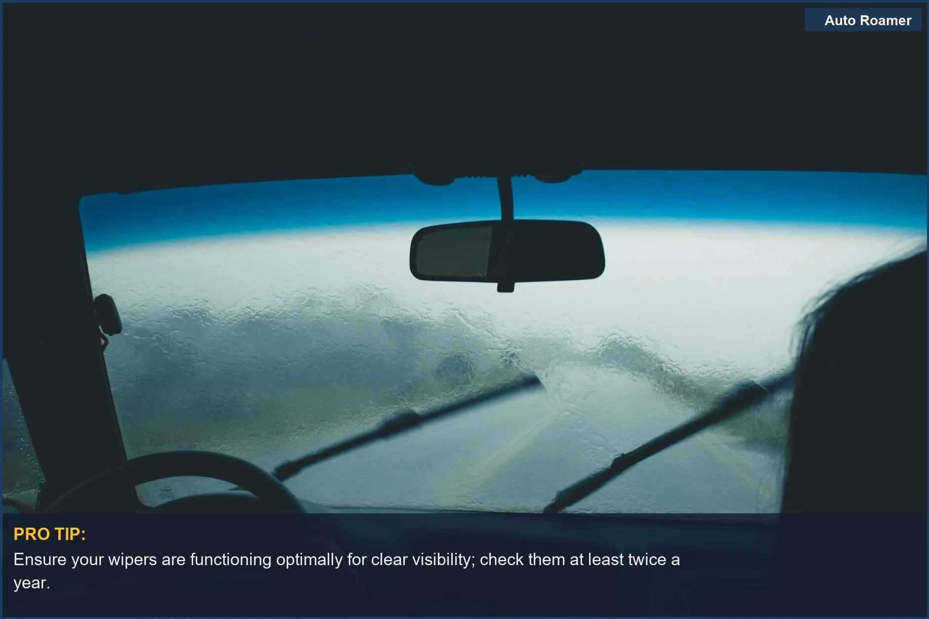 Rainy day car interior view with wipers, illustrating when to use hazard lights legally and safely.