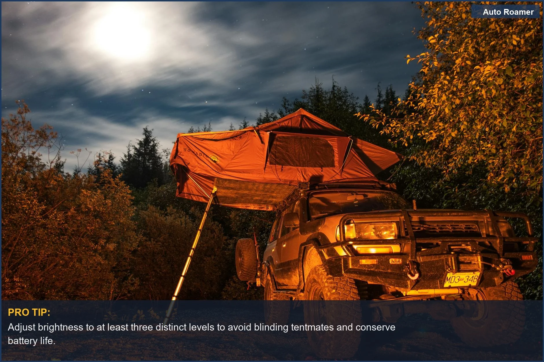 Car camping headlamp features: Person using a bright headlamp at a campsite with a Jeep and rooftop tent at night.