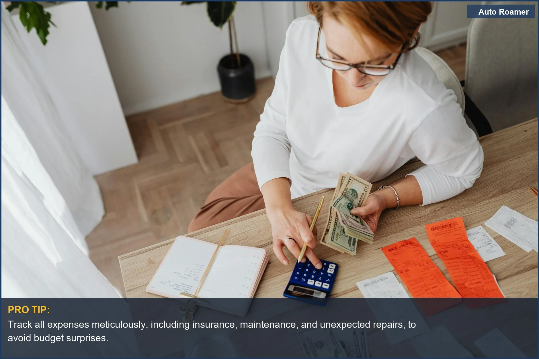 Woman organizing bills and calculator, representing the financial management of owning a car and its hidden costs.